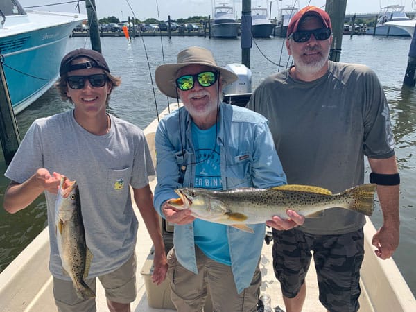 3 men holding fish