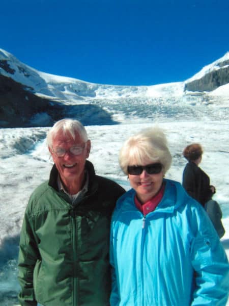 man and woman in front of snowy mountain