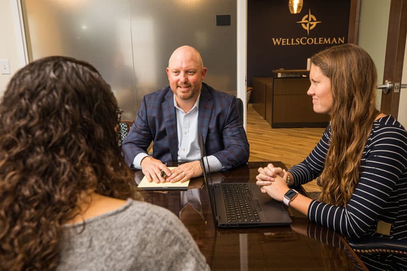 three people in conference room talking