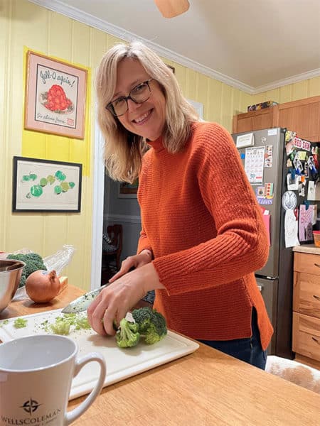 woman chopping broccoli