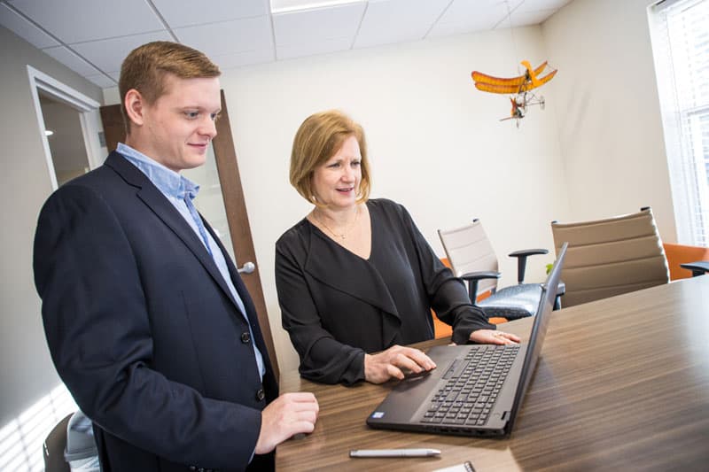 two people looking at laptop