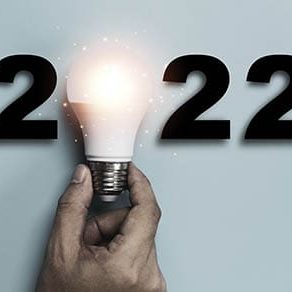 Hand holding Light bulb with 2022 year for happy new year idea and creative thinking concept.